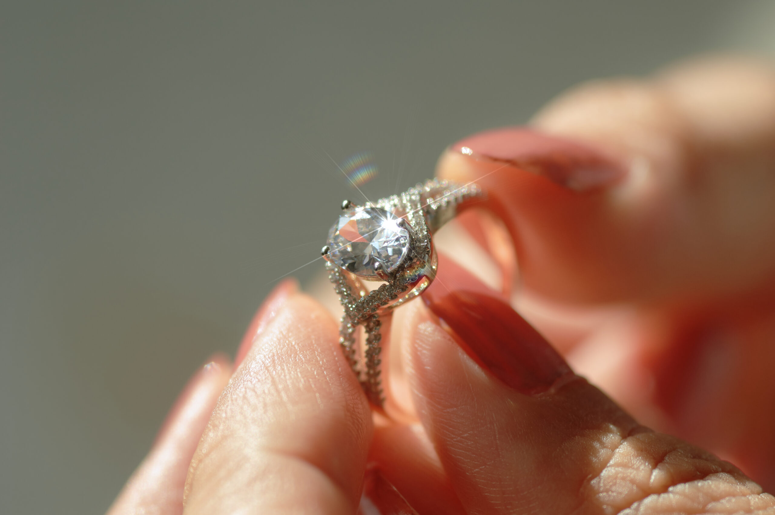 Customer inspecting a diamond ring by hand