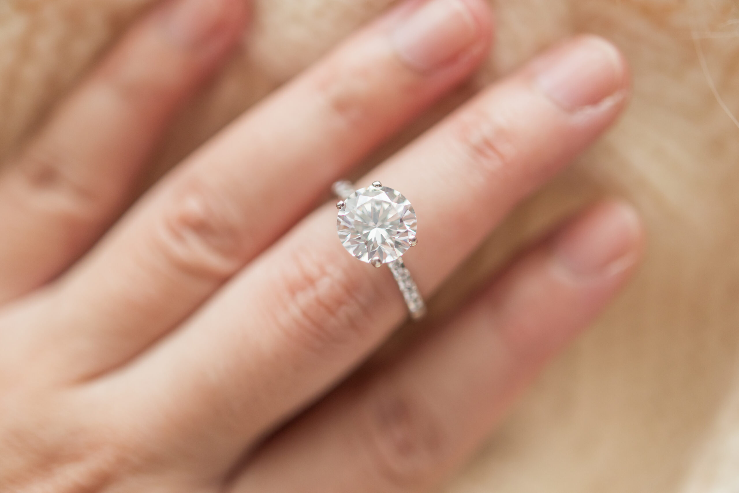 Round diamond ring on a woman's hand