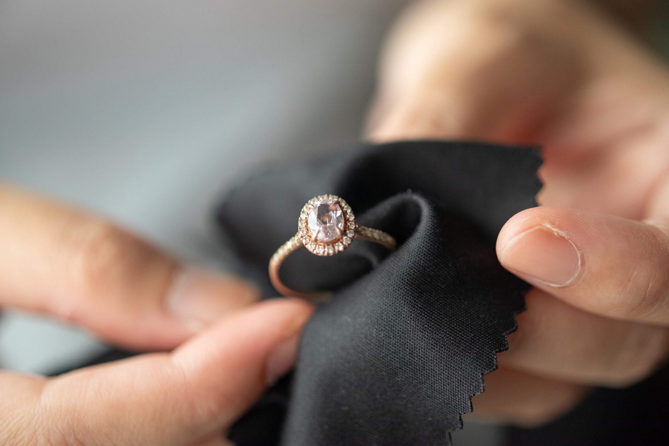 Jeweller inspecting a diamond ring with black gloves
