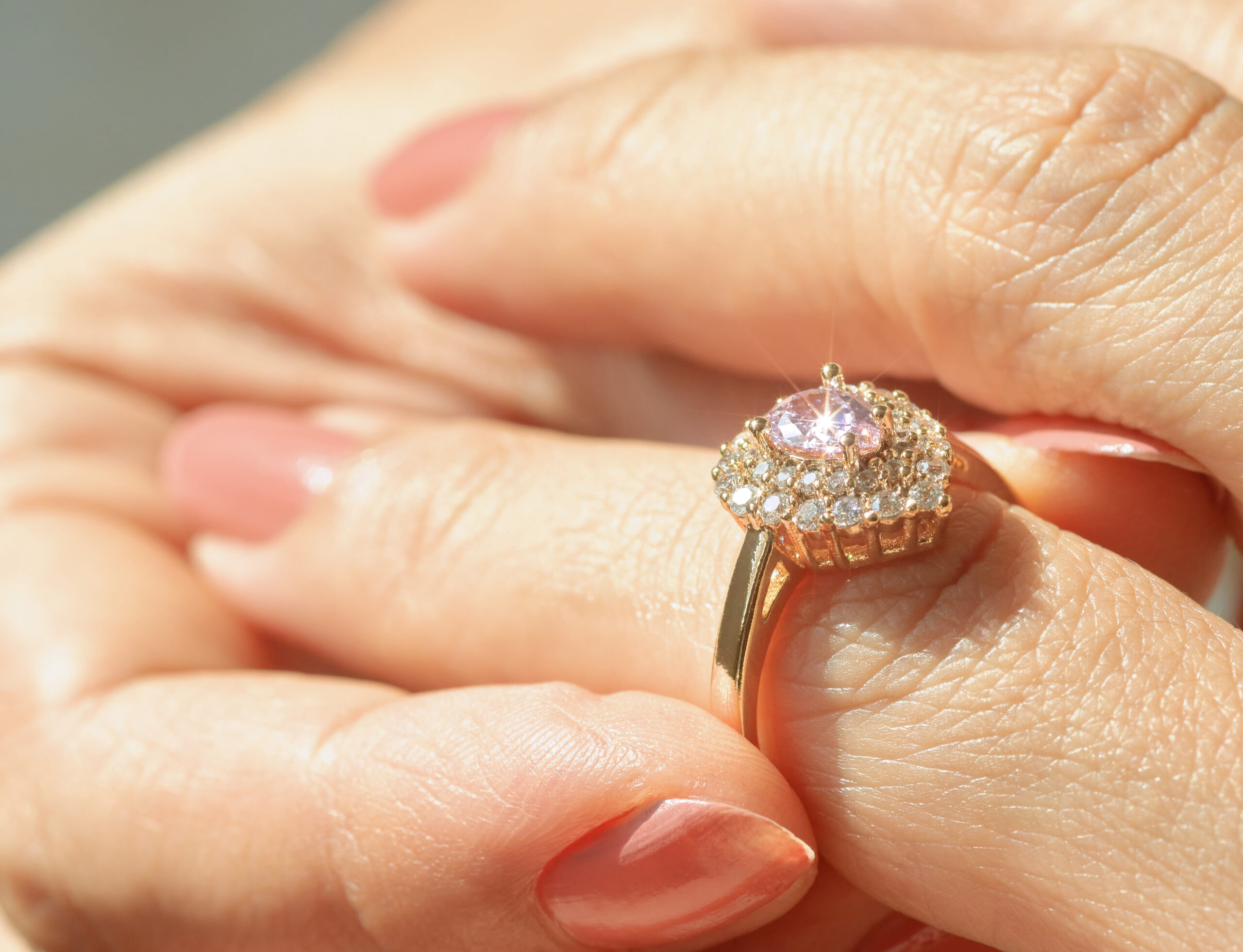 Large diamond engagement ring held by hand