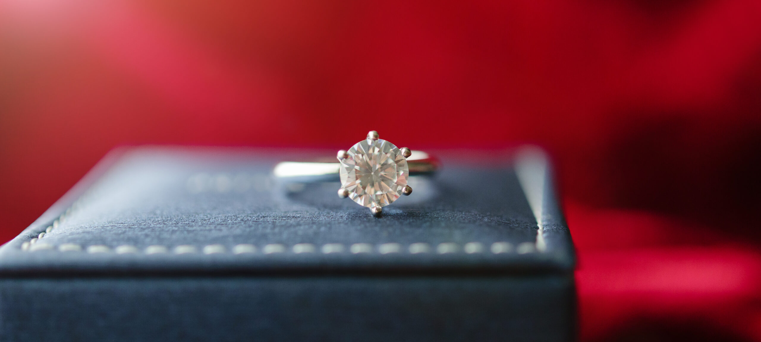 Diamond ring presented in a red jewellery box